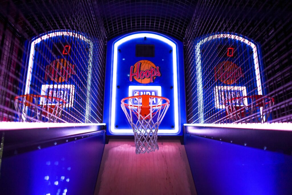 three arcade basketball hoops with lights