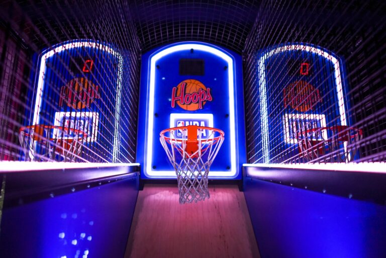 three arcade basketball hoops with lights