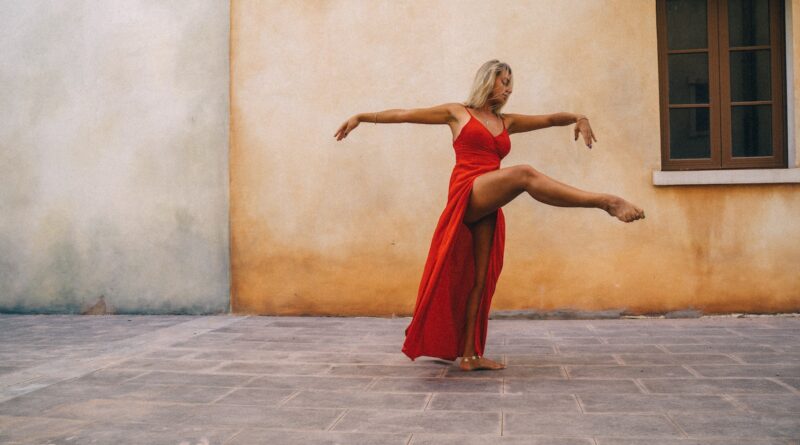 Woman in Red Dress Dancing on a Courtyard